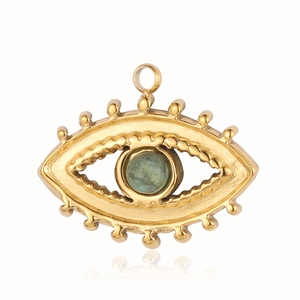 Detailed view of evil eye gold stainless steel pendant with a green gemstone center