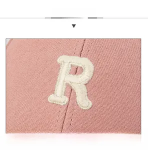 Close-up of pink cotton baseball cap featuring high-quality 3D embroidered letter R
