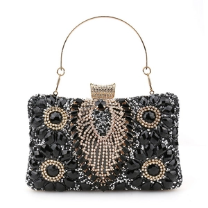 Elegant black rhinestone evening clutch bag with gold handle and sparkling gems