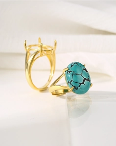 Detailed comparison of a gold four-prong ring setting and a finished turquoise ring