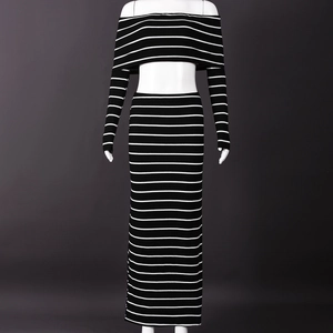 Detail of black and white striped off-shoulder top and high-waist bodycon skirt set
