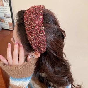 Detail view of red and brown tweed knit headband with vintage french style texture