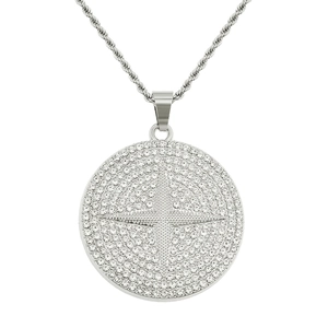 Detailed macro of a silver iced-out round pendant with star motif on a rope chain