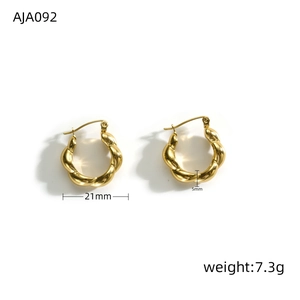 Macro shot showing dimensions and thickness of twisted 18k gold-plated hoop earrings