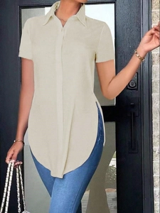 Detail of beige short sleeve polo shirt featuring high side slits and tailored turn-down collar