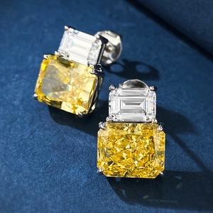 Macro view of S925 silver stud earrings with yellow radiant cut stone and white zircon