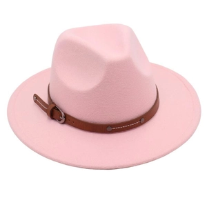 Detail of pink wide brim fedora hat featuring a brown leather band and silver buckle