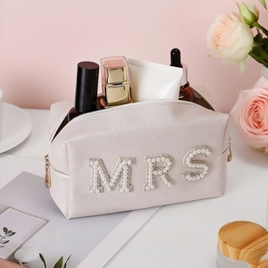 Pearl Mrs bridal makeup bag in white faux leather with gold zipper for wedding