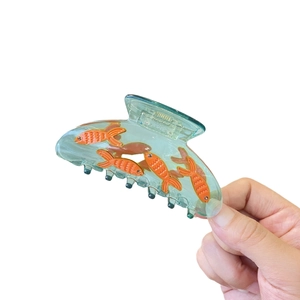 Creative fish tank hair claw clip in translucent blue acetate with orange goldfish