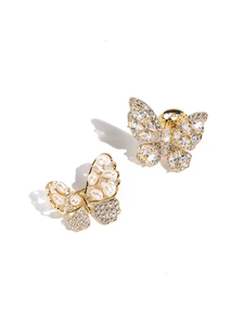 Detailed close-up of gold butterfly brooches with white pearls and sparkling cubic zirconia
