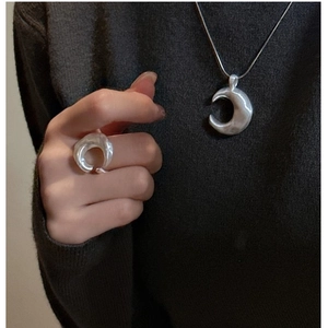 Detail of S925 sterling silver crescent necklace and ring set with hand-hammered texture