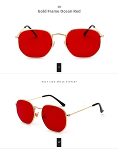 Detalle de las gafas de sol doradas con lentes rojo océano y puntas de las patillas negras