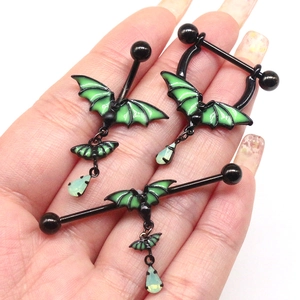 Close-up of gothic bat nipple rings in black and neon green with teardrop charms