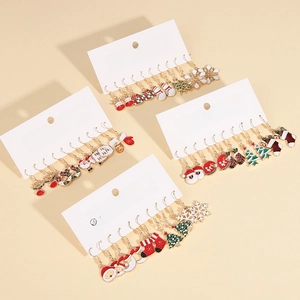 Close-up of alloy enamel Christmas earrings set featuring Santa, snowman and snowflake designs
