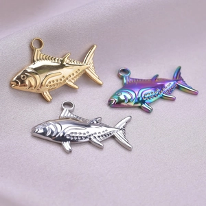 Detailed view of fish-shaped stainless steel pendants in gold, silver, and rainbow finishes