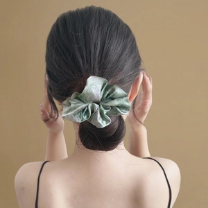 Starry blue oil painting satin scrunchie with marble pattern on a bun hairstyle