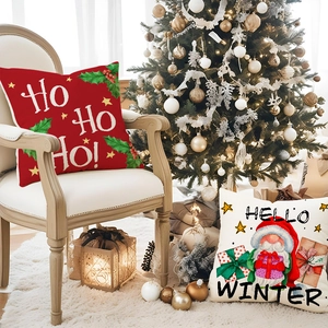 Christmas cushion covers with Ho Ho Ho and Hello Winter prints on cozy armchair
