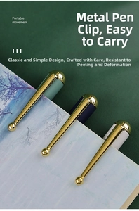 Close-up of Morandi business pens with gold clips clipped to a paper notebook