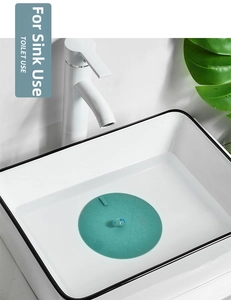 Green dinosaur silicone sink stopper with shell texture shown in a water-filled basin