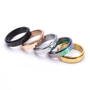 Five titanium steel rings showing hammered textures in black, gold, and silver finishes