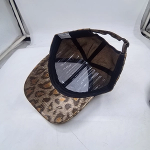 Detail view of leopard print baseball cap interior showing 100% polyester fabric label