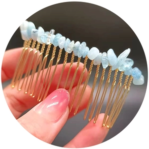 Handmade gold metal hair comb featuring light blue crushed crystal stones for elegant styling