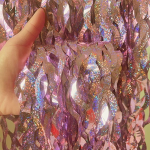Close-up of purple laser shimmer foil curtain with wave fringe for party backdrop