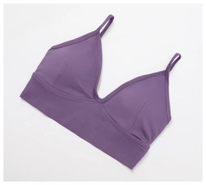 Detail of purple ribbed seamless sports bra with V-neckline and elastic support band