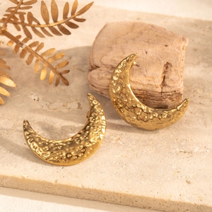 Golden crescent moon stud earrings with hammered metal texture in a minimalist retro style