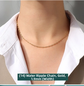 Close-up of 1.9mm golden water wave chain necklace worn with an elegant suit