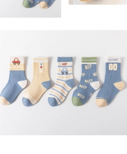 Detail of five pairs of cotton children socks with blue beige green cartoon car patterns