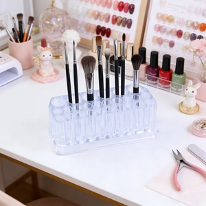 Transparent acrylic nail brush holder with 26-hole design on a tidy workstation