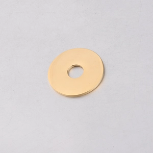 Close-up of a polished gold stainless steel circular pendant with center hole