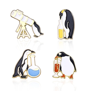 Set of four penguin enamel brooches with science laboratory and telescope themes