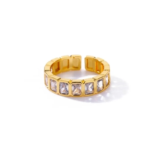 Close-up of golden adjustable ring with rectangle zircon stones and polished finish