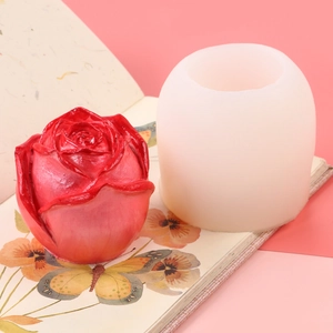 Close-up of red rose candle and white silicone mold for DIY aromatherapy crafts