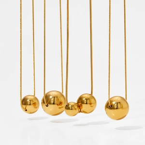 Minimalist gold plated hollow ball pendant necklace with polished mirror finish on snake chain