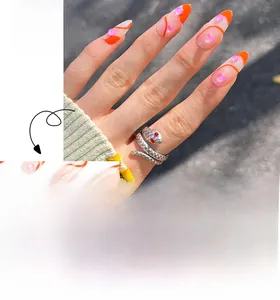 Detail of orange French tip almond nails with 3D pink pearls and wavy line art