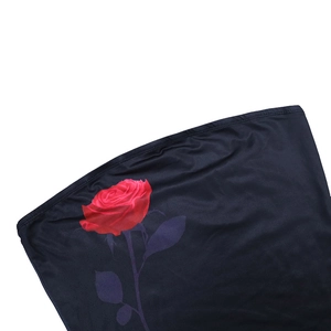 Close-up of red rose floral print and fine stitching on dark tube top fabric