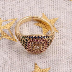 Detailed close-up of a gold-plated adjustable ring with multi-colored zircon stones