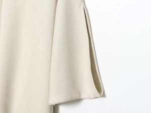 Detailed close-up of high-quality twill fabric texture and clean edge stitching in beige