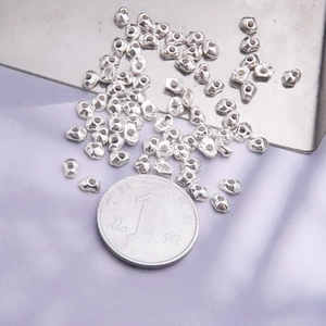 Macro shot of irregular S925 silver beads for DIY jewelry making with size reference