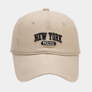 Detailed embroidery of NEW YORK 1625 text on washed beige cotton baseball cap