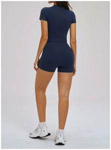 Rear view of navy blue two-piece yoga set featuring a cropped top and high waist shorts