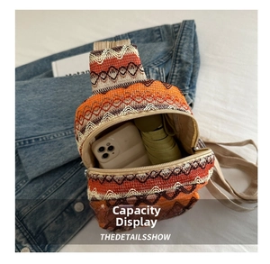 Ethnic woven chest bag showing spacious interior with smartphone and folding umbrella