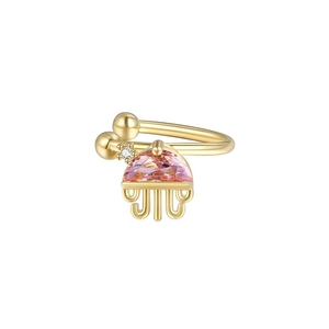 Detailed close-up of jellyfish-shaped earring with pink gemstone and gold tentacles