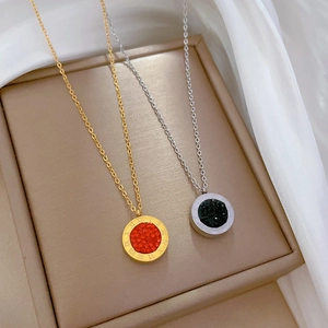 Detail of Roman numeral pendants in gold and silver with red and black gemstone inlays