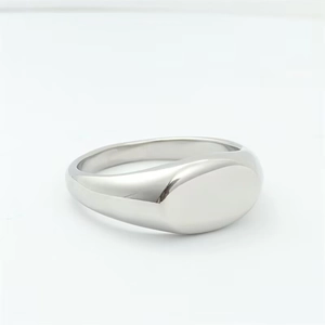 Polished silver titanium steel signet ring with a smooth oval face on white background