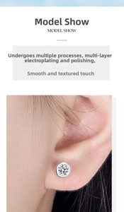 Close-up of minimalist silver zircon screw back stud earring worn on the earlobe