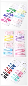 Detail of colorful drip oil candy BB hair clips on white card packaging set